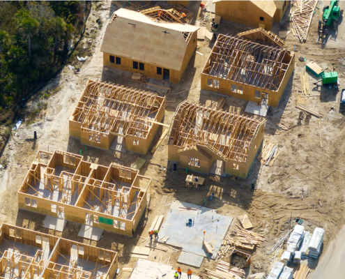 Aerial view of multiple homes being constructed in a residential neighborhood