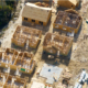 Aerial view of multiple homes being constructed in a residential neighborhood