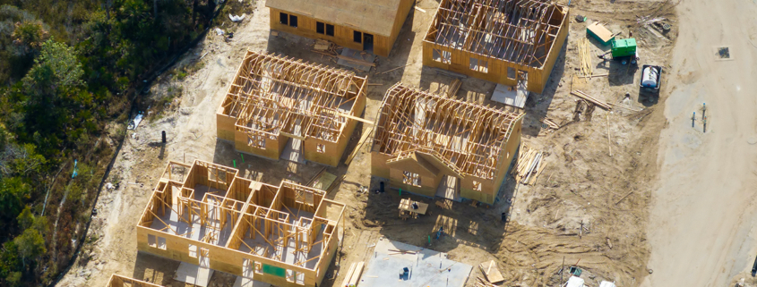 Aerial view of multiple homes being constructed in a residential neighborhood