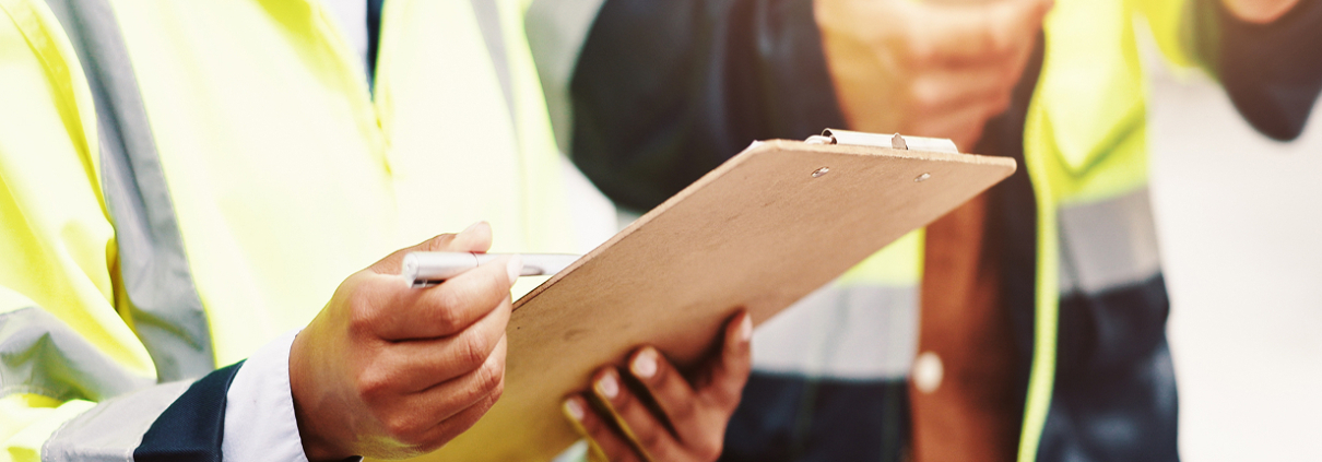home inspector with clipboard in hand, checking off inspection points