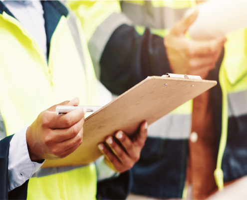 home inspector with clipboard in hand, checking off inspection points
